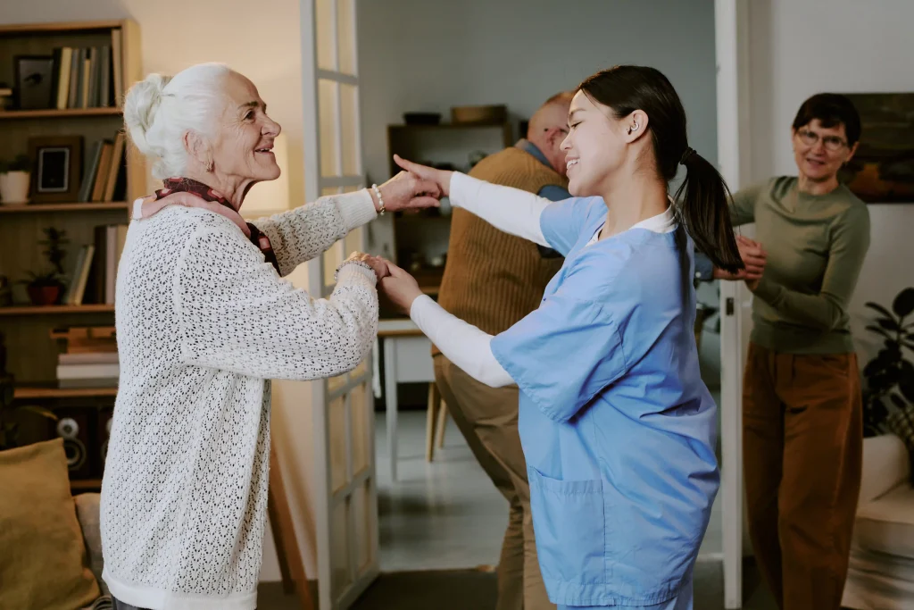 senior woman dancing with young adult hispanic fem 2026 01 11 10 59 23 utc